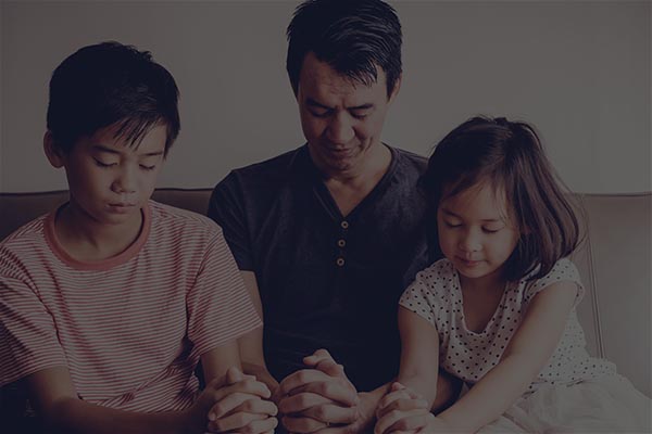 Multicultural asian children praying with their father at home, family pray